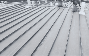Commercial metal roof repair and restoration on a flat roof in Austin, Texas.
