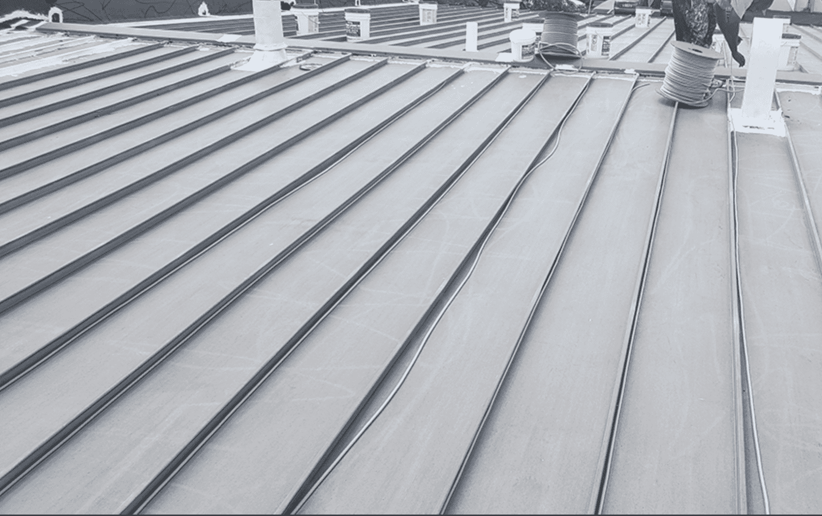 Commercial metal roof repair and restoration on a flat roof in Austin, Texas.