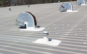 Commercial metal roof with vents and restoration needed