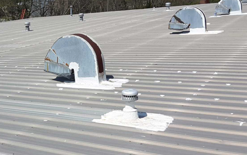 Commercial metal roof with vents and restoration needed