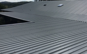Commercial metal roof restoration and repair on a large building in Austin.
